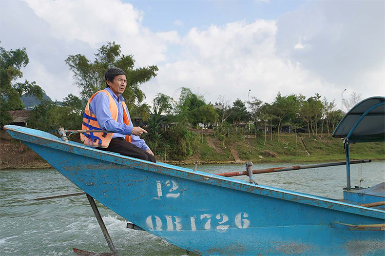 Vietnamese man sitting on a boat